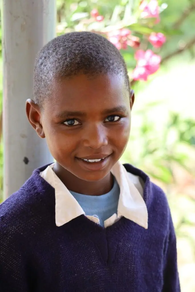 A young boy is smiling for the camera.