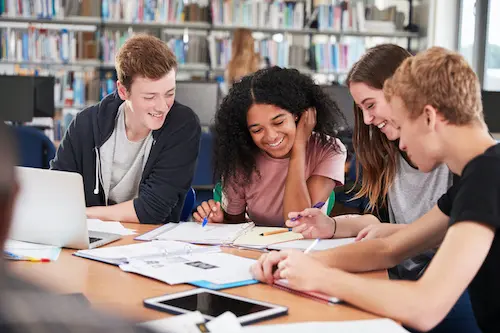 Students studying together at library table