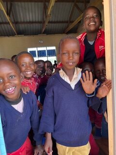 A group of children standing in front of a door.