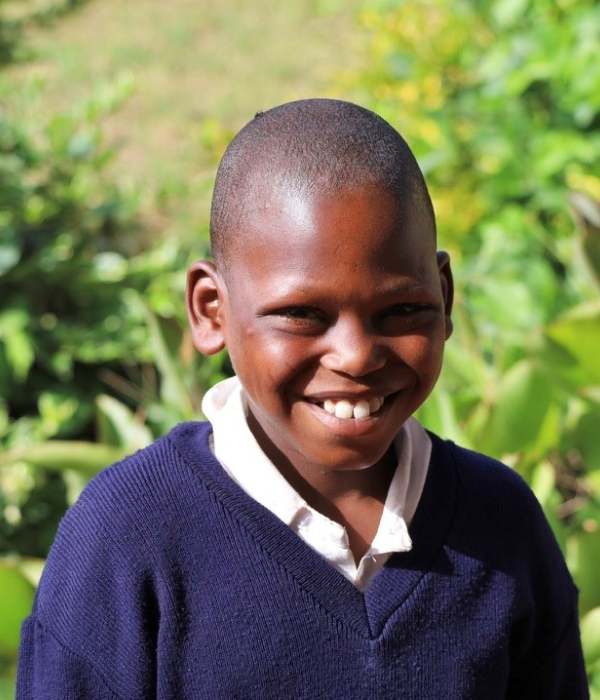 A young boy smiling for the camera.