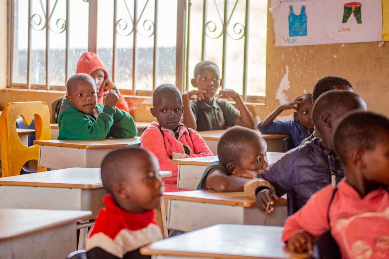 A group of children sitting in a classroom.