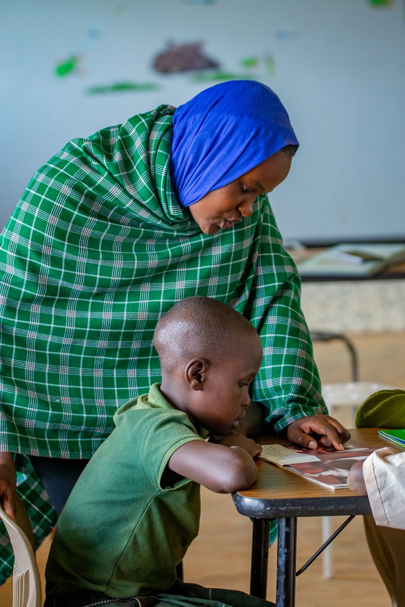 A woman and child are sitting at a table.